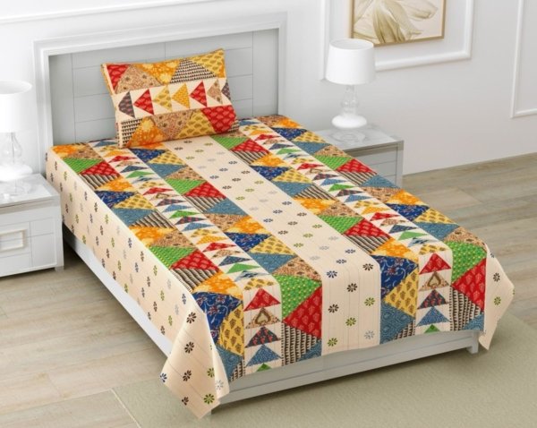 ingle bed sheet and pillow cover set in yellow. The bed sheet features a patchwork design with geometric Barmeri prints in various colors.