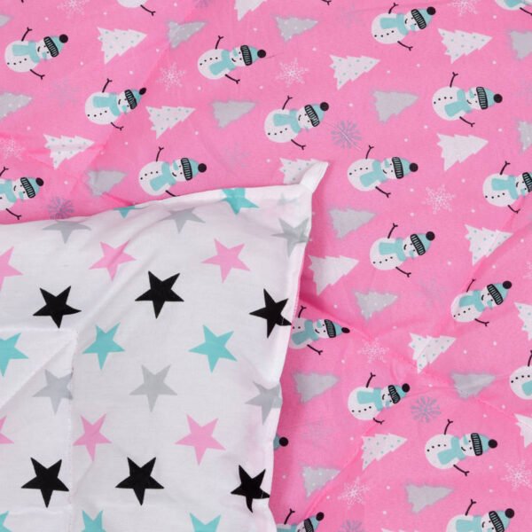 a reversible comforter with pink snowman print on one side and white on other side.