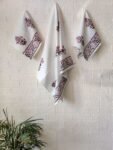 Hand and bath towel set of 3, featuring white towels adorned with pink flowers.
