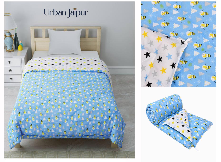 Urban Jaipur cotton comforter, it features a reversible print,  blue color on one side and white color on other side. The image here has three angles of comforter - 1. main angle - it showcases the comforter on bed, also shows the reversible print. 2. second angle - it shows the reversible print of the comforter 3. third angle in the image shows how the comforter would look like folded, what size the comforter would look like. 