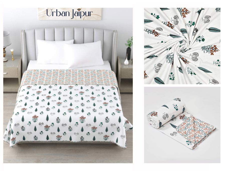 A fine hand-block printed, reversible cotton dohar from  Urban Jaipur, with three difference angles, main angle showcases the dohar on bed. Second angle show the dohar curled - to showcase it's fabric, and third angle shows the reversible print of the dohar 