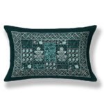 Green pillow cover featuring an elegant blue and white embroidered design.