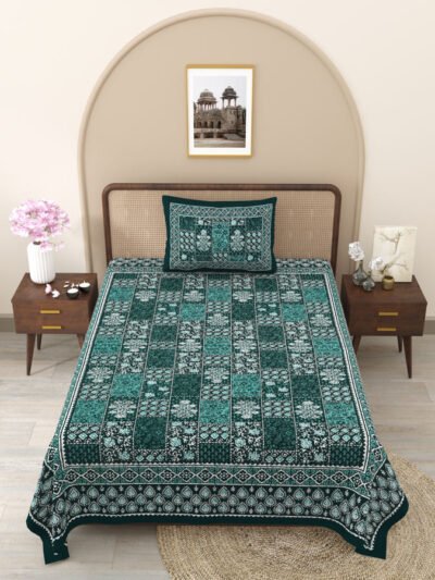 A single bed with a green and white bedsheet and matching pillow cover.