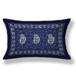 blue pillow features a delicate white floral design