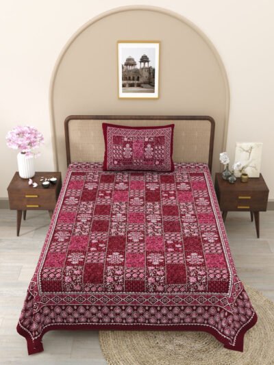 A cozy red and white bed with a stylish red and white pattern