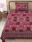 close view of a cozy red and white bed with a stylish red and white pattern