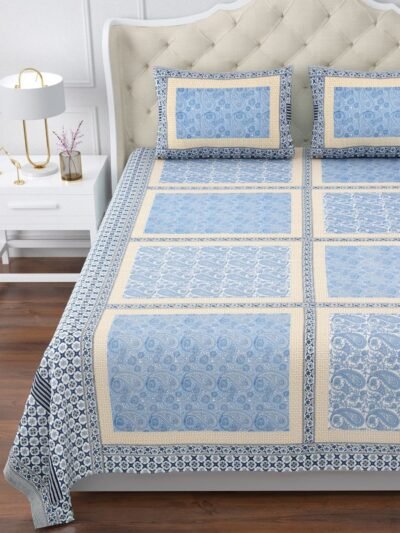 A king size Blue and white bedspread with a beautiful floral pattern, spread nicely on bed.