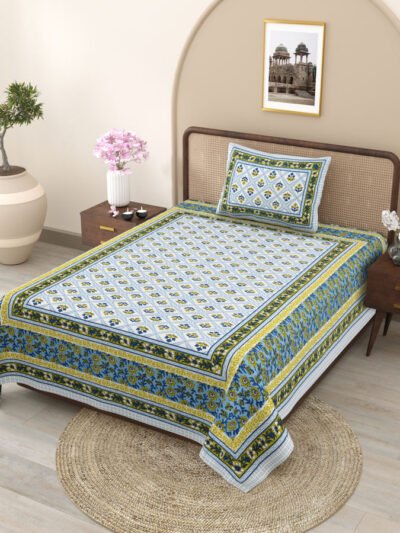 A single bed with a blue and yellow bedsheet and matching pillow cover.