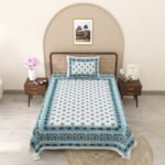 A comfortable single bed featuring a pure cotton bedsheet in a soothing blue and white color scheme.
