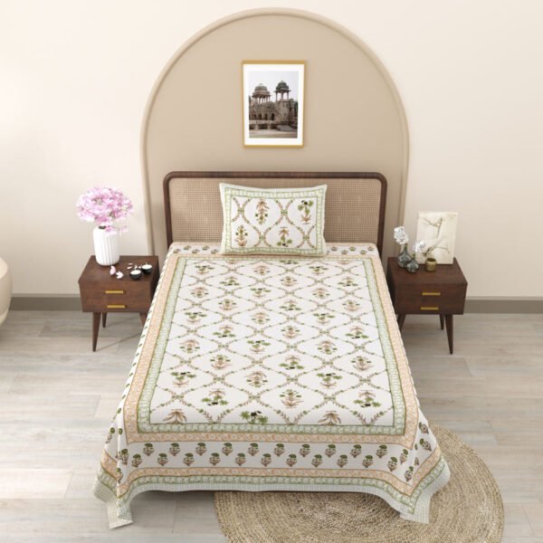 A single bedsheet with a white and green floral pattern, accompanied by a matching pillow cover.