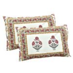 Two rectangular decorative pillows with a consistent floral design. Each pillow has a central white panel with a trio of red flowers, surrounded by intricate border patterns in red, teal, yellow, and green.
