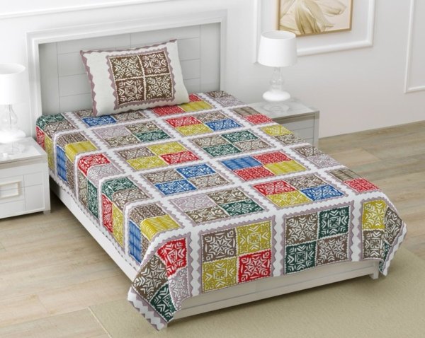 Light blue single bed sheet with a Barmeri patchwork design featuring geometric shapes and elephant motifs in shades of blue, green, and yellow. The bed sheet has end-to-end stitching.