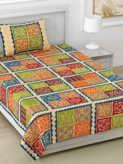 yellow single bed sheet with a Barmeri patchwork design featuring geometric shapes in shades of blue, green, and yellow. The bed sheet has a decorative blue border and end-to-end stitching.