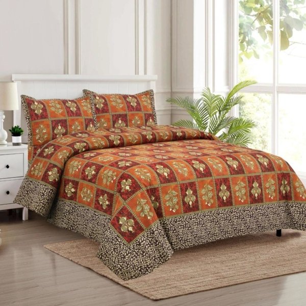 An orange and brown bedsheet with a block pattern covers a bed.