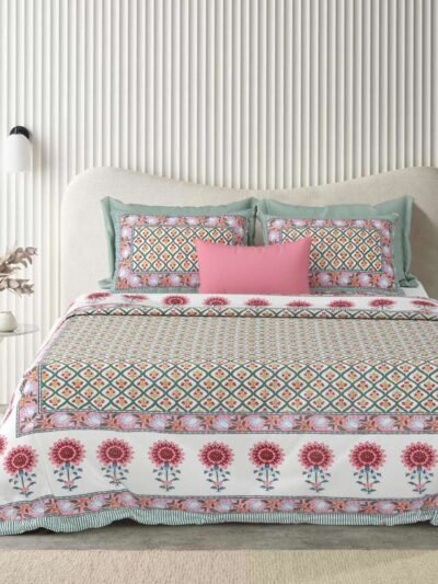 a bed with a floral pattern bedsheet on it