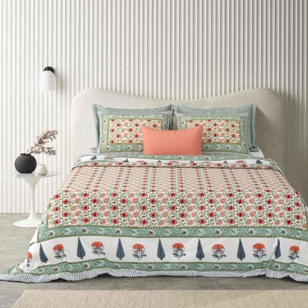 a bed with a floral comforter and pillows