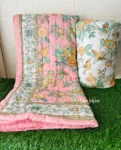 a pink blanket and pillow on grass