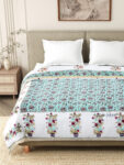 closeup look of bed with jaipuri razai on it and two pillow covers