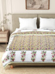 closeup look of bed with jaipuri razai on it and two pillow covers