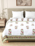 closeup look of bed with jaipuri razai on it and two pillow covers