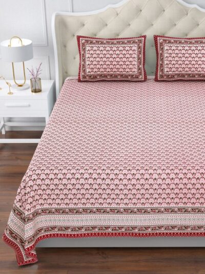 Add a splash of charm to your bedroom with this beautifully designed pink and red floral bedsheet set. Featuring traditional block print patterns inspired by Indian heritage art, this set brings together elegance and coziness effortlessly. The vibrant red border provides a striking contrast to the delicate pink base, creating a balanced and inviting look. Made from premium 100% cotton, this Super King-size bedsheet is soft, breathable, and perfect for all-season comfort.